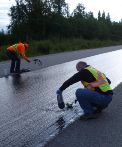 Asphalt Sealcoating Contractors sealcoating a road in Tampa